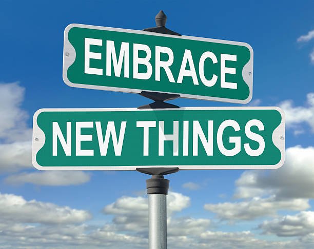 Embrace New Things Street Sign. This is a useful image to illustrate the idea of accepting change, new technology, or new experiences.
